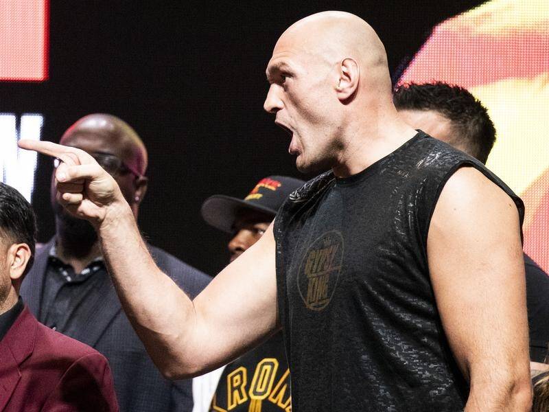 Tyson Fury yelling at heavyweight title opponent Deontay Wilder (not pictured) at their weigh-in.