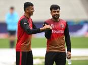 Mujeeb Ur Rahman (l) and skipper Rashid Khan have led Afghanistan to a first T20 win over Pakistan. (James Ross/AAP PHOTOS)