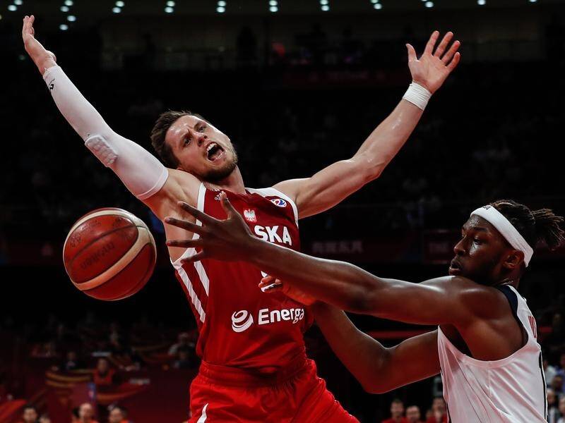 Myles Turner (R) of the US in action against Mateusz Ponitka (L) of Poland.
