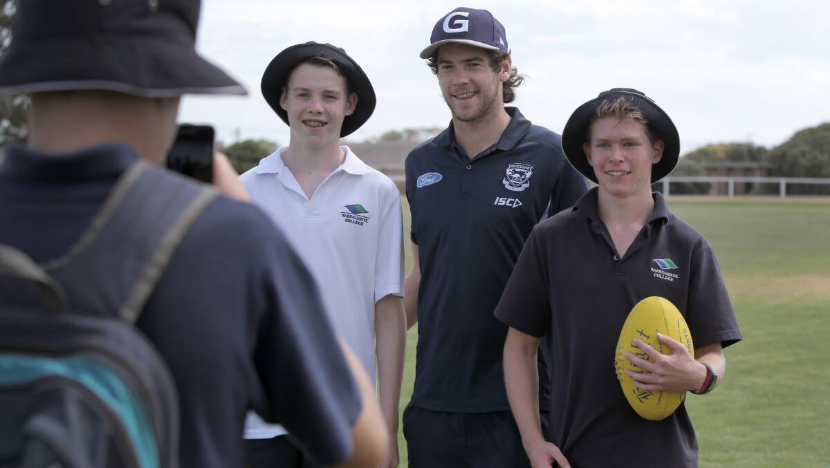 Geelong recruit and ex-Noorat player Nick Bourke poses with Warrnambool College students Lam Stow (left) 14, and Joe Richardson, 15.