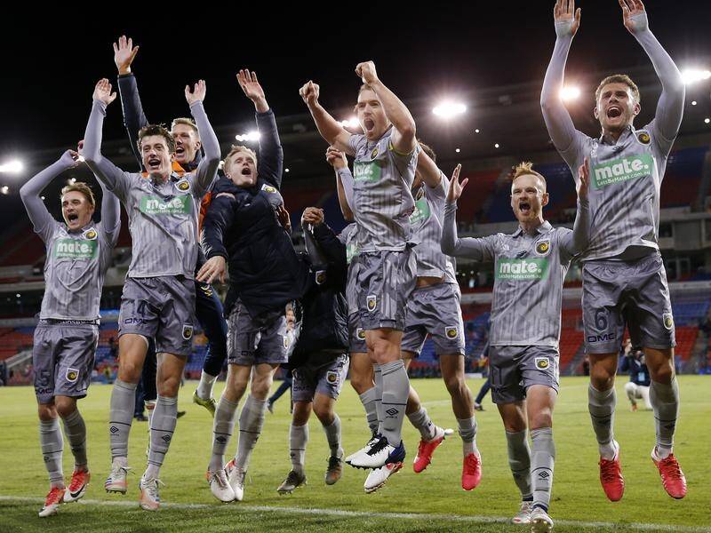 Mariners players celebrate their derby win over Newcastle which took them second in the A-League.