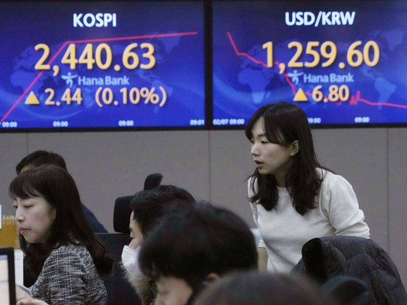 Asian shares tracked Wall Street, which ended higher in choppy trading after Jerome Powell's speech. (AP PHOTO)