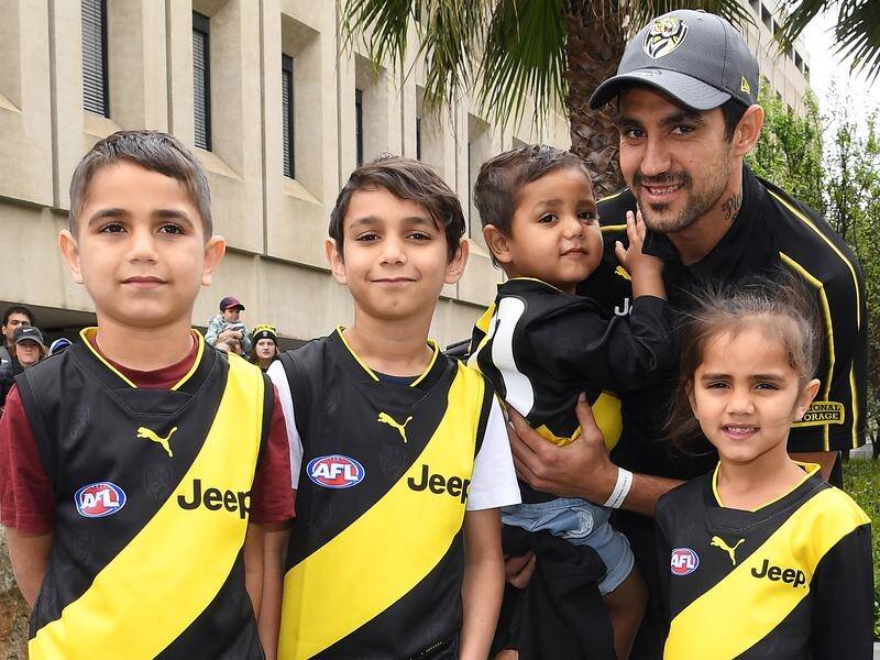 Richmond's Marlion Pickett poses with his children at the AFL grand final parade in Melbourne.