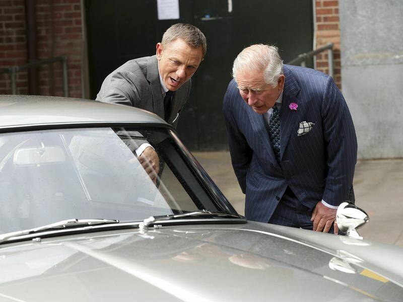 Daniel Craig showed Prince Charles two of James Bond's Aston Martin cars during the royal's visit.