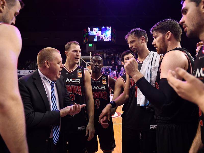 Hawks' coach Rob Beveridge congratulates his players for their win over Melbourne.