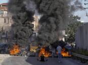 Protesters set fire to tyres after two Palestinians were shot and killed in the occupied West Bank. (AP PHOTO)