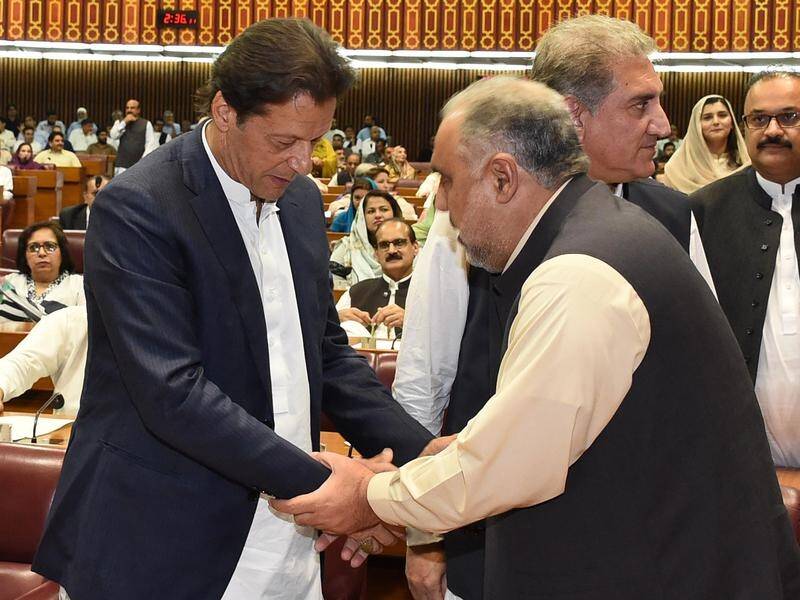 Cricket legend Imran Khan (L) has been elected by Pakistan MPs as the country's new prime minister.