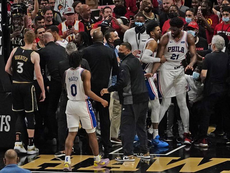 Philadelphia and Atlanta players are separated after a brief scuffle during the 76ers' 104-99 win.