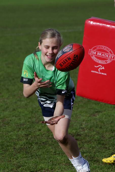 Renee Savlitis, 11, is all smiles during the skills and fitness session at Reid Oval. 140707AS21 Picture: AARON SAWALL