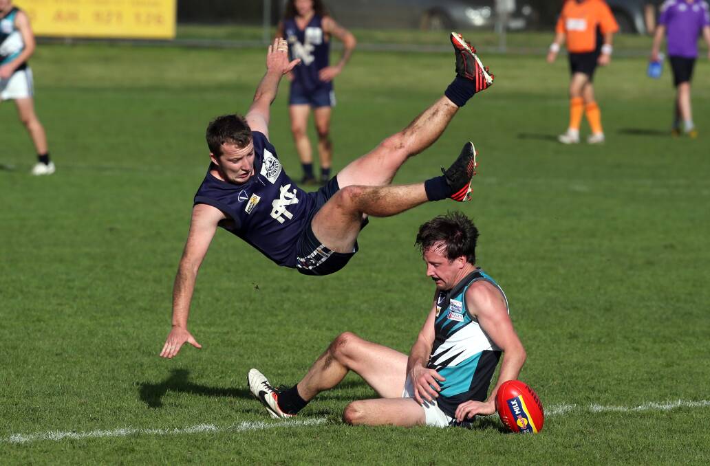 Kolora-Noorat utility Tim Attrill sends his Nirranda opponent Michael Foster flying in a ground-level contest. Picture: DAMIAN WHITE
