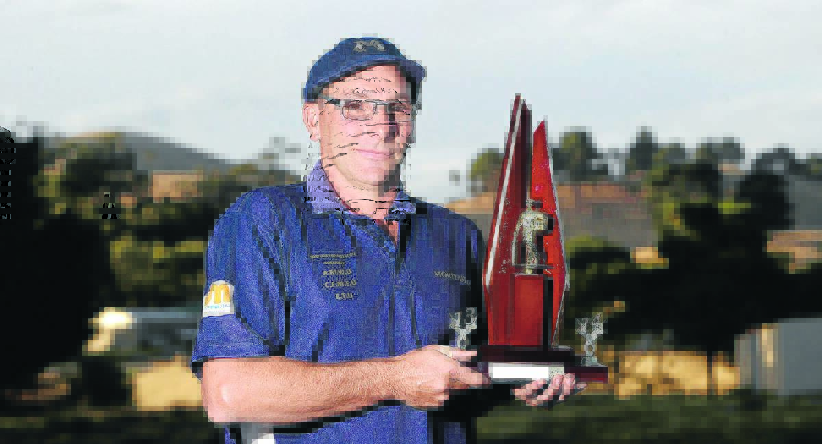 Mortlake’s Shane Slater proudly displays his SWC cricketer of the year award. last night. 