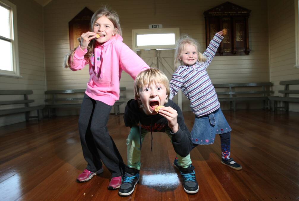 Siblings Monique Brown, 11, Ryleigh, 8, and Kaitlyn, 5, get in some early taste-testing practice for the Kirky Bikkie Bake-off.  Picture: VICKY HUGHSON