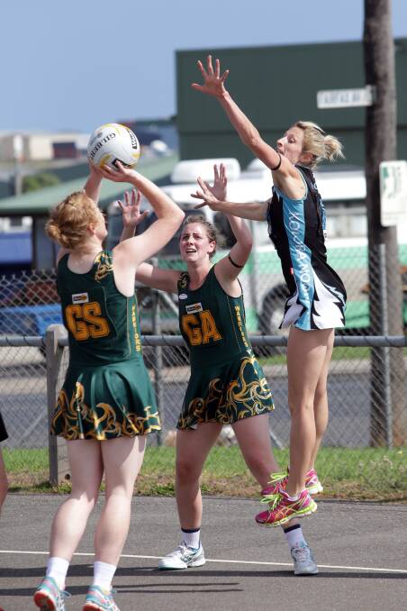 Kolora-Noorat’s Kelly Mullen attempts to stop Old Collegians’ Steph Townsend’s shot at goal as Sophie Ballinger provides support for her Warriors’ teammate.  Picture: DAMIAN WHITE
