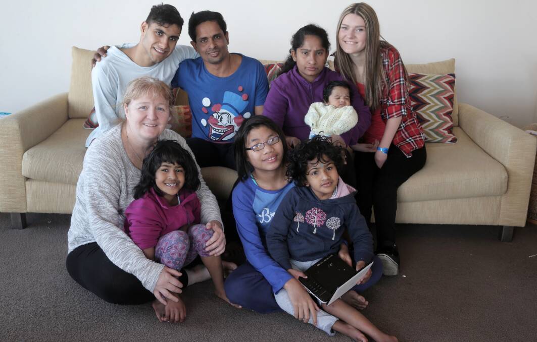 Humanitarian and mum Moira Kelly (front left) with her growing family Trishna, 7, (in lap), Papa Oo, 12, Krishna, 7, (back from left) Emmanuel, 20, Katick Mollick, Lovely Mollick, holding Matthew Mollick, 9 weeks, and Mimoza, 17. 140708RG01 Picture: ROB GUNSTONE
