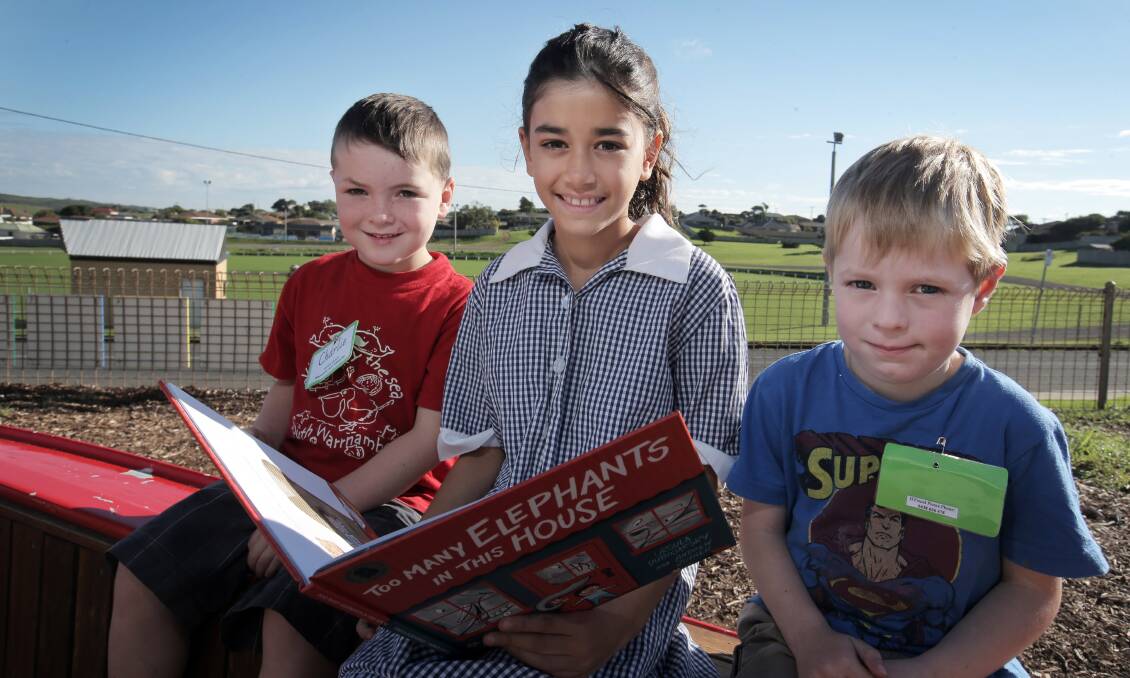 Merrivale Primary School pupil Jasmin Paton, 9, reads to South Warrnambool kinder pupils Charlie Mahony-Gilchrist, 4 (left) and Nathaniel Clark, 4, during yesterday’s National Simultaneous Storytime at the school. Picture: ROB GUNSTONE