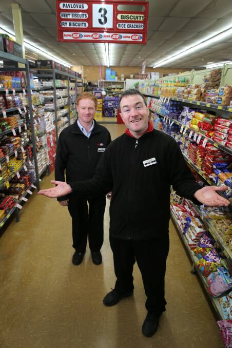 Michael Kearney has not let an intellectual disability stop him clocking up 10 years’ employment at Swinton’s IGA supermarket, says store manager Brett Maloney (left). Picture: ROB GUNSTONE
