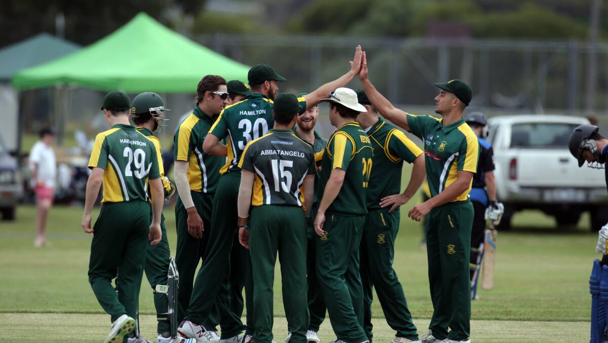 Northcote players celebrate a wicket in Saturday’s VPC clash with Melbourne University at Port Fairy’s Avery’s Paddock. 