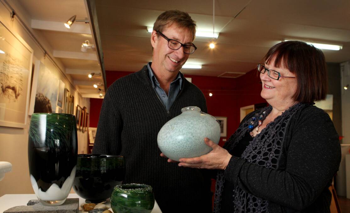 Artist Freya Marriott shows festival co-ordinator Ross Morey one of her blown glass pieces on display at Whale Bone Gallery during the Winter Weekends.  