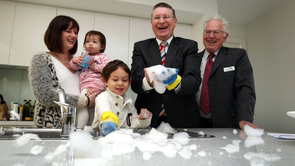 Warrnambool mother Rebecca Kimura, with 18-month-old daughter Esther and son Oliver, 3, Premier Denis Napthine and Wannon Water director Russell Worland, will be among those to benefit from a drop in water costs.