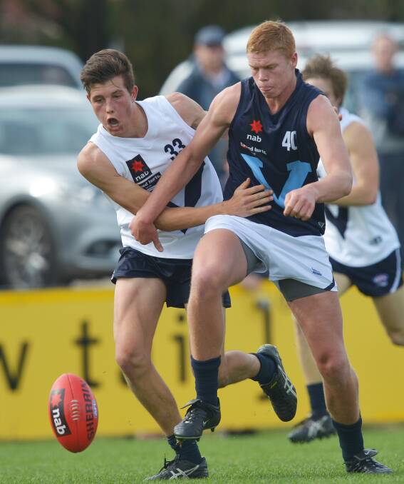 Portland’s Vic Country ruckman Rowan Marshall (left) pressures Metro opponent Peter Wright, who is touted as a top-three national draft pick.