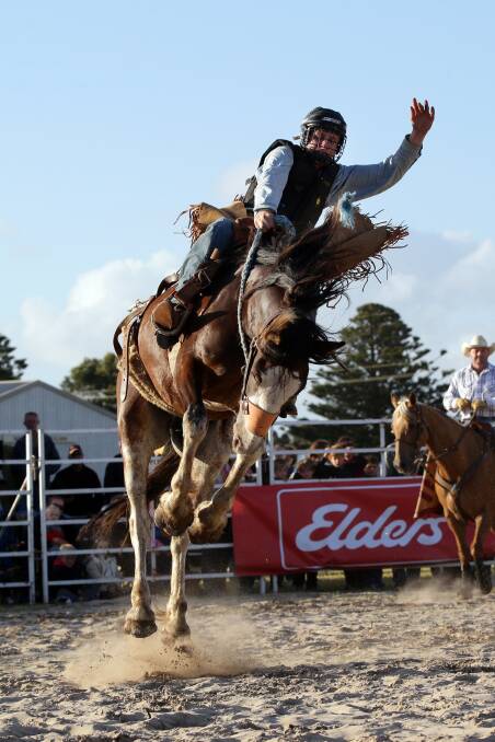 Saddle bronc competitor Beau Kerr maintains contact with the saddle at Port Fairy Rodeo on Saturday.