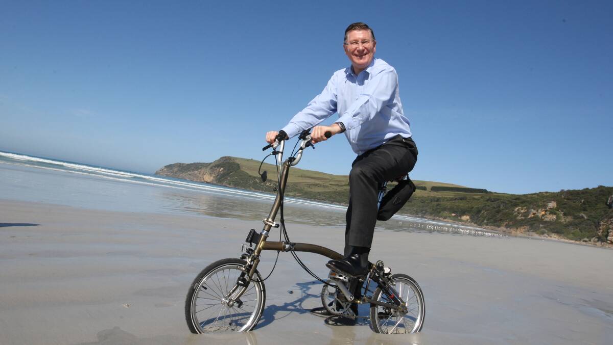 Premier and Member for South West Coast Denis Napthine rides a bike along Bridgewater Beach. Picture: ANGELA MILNE 