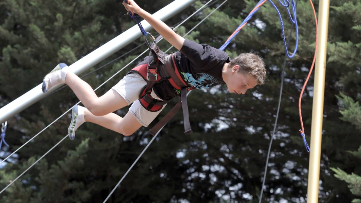 Tanner Fratantaro, 10 of Simpson, gets some air on the bungy trampoline. 
