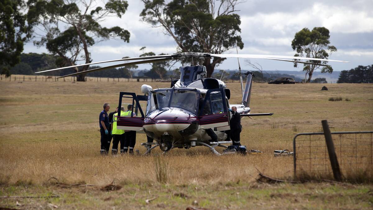 An Air Ambulance helicopter landed in a nearby paddock to transport the injured driver of the car to hospital. Picture: DAMIAN WHITE 
