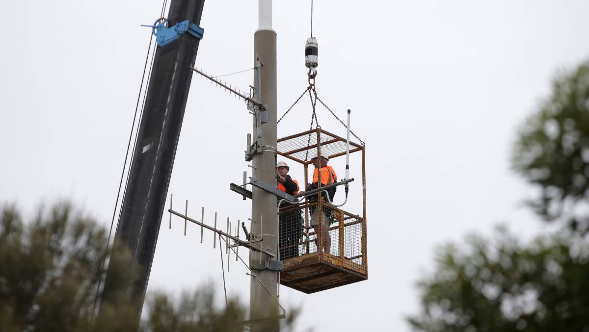 Sub-contractors at work on the Warrnambool City television transmission tower this morning. The work has left TV screens blank across the city. Picture: DAMIAN WHITE