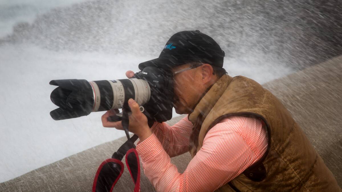 Warrnambool amateur photographer Perry Cho gets soaked while capturing some spectacular images of waves crashing over the breakwater. 
