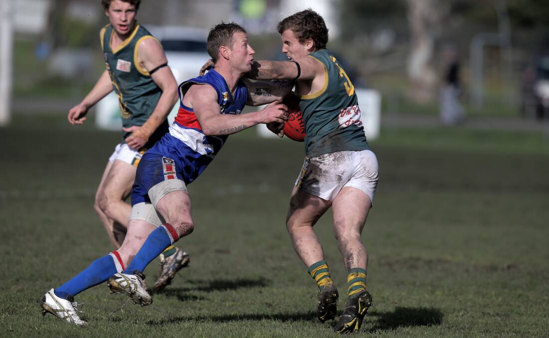 Panmure playing coach Simon O’Keefe lays a tackle on Old Collegians’ Josh Walsh during Saturday’s hard-fought win by the Bulldogs. 140802LP32 Picture: LEANNE PICKETT