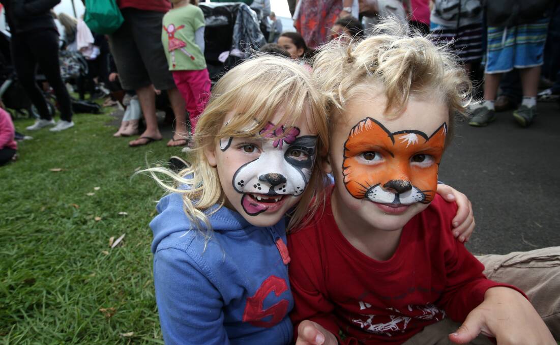 Abi Langley, 6, and her brother Jack, 4, of Kirkstall, enjoy the expanded Easter Fair in Port Fairy on Saturday which included face-painting. 