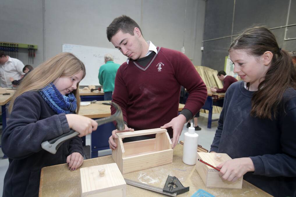 Brauer College VCAL student Daniel Le Cerf, 18, works with Merrivale Primary School pupils Kayla Neave, 10 (left), and Lelou Berger, 11, on a woodwork project. 140729RG05 Pictures: ROB GUNSTONE