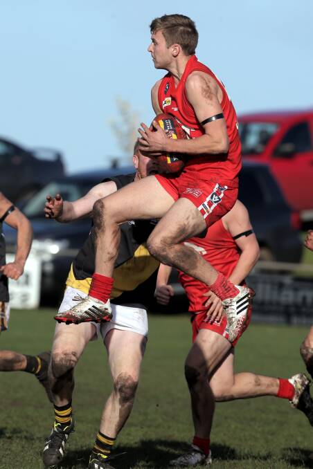 Dennington’s Alex Pye leaps high to secure a chest mark during Saturday’s commanding 39-point win against Merrivale. 140802LP60 Picture: LEANNE PICKETT