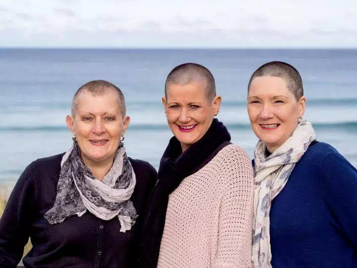 Gill Wheaton (left), Julie Small and Deb Johnstone rug up after having their heads shaved for the Leila Rose Foundation last week. 