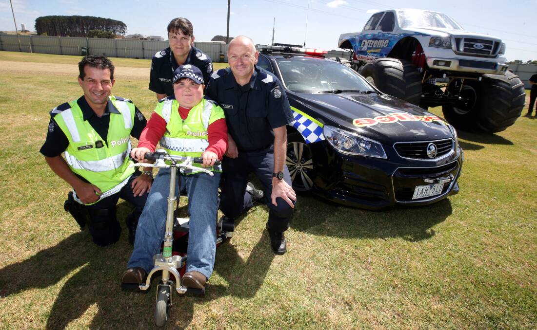 Warrnambool highway patrol members Senior Constable Greg Kew (left), Senior Sergeant Tania Barbary and Sergeant Sean Halley support Tom Meade before a monster truck show at Allansford. 