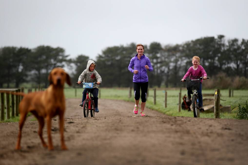 Mepunga East runner Tania Nevill has familiar company for a farm run — her children Hayden, 5, Matilda, 7, and family dog Tovah. 141002DW29 Picture: DAMIAN WHITE