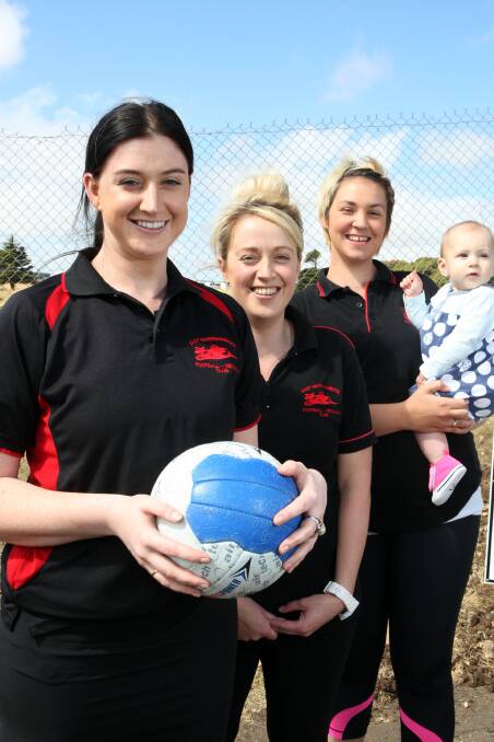New East Warrnambool A grade coach Aimee Drew (left), A reserve coach Emily Sherman and 17 and under and B grade coach Brooke Williams, with daughter Pippa Herbertson, nine months. 