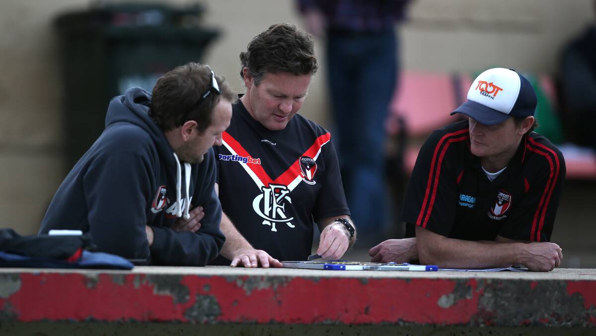 Koroit senior coach Adam Dowie (centre) tries to plan the Saints’ next move with Mathew Buck and Andrew Paton. 