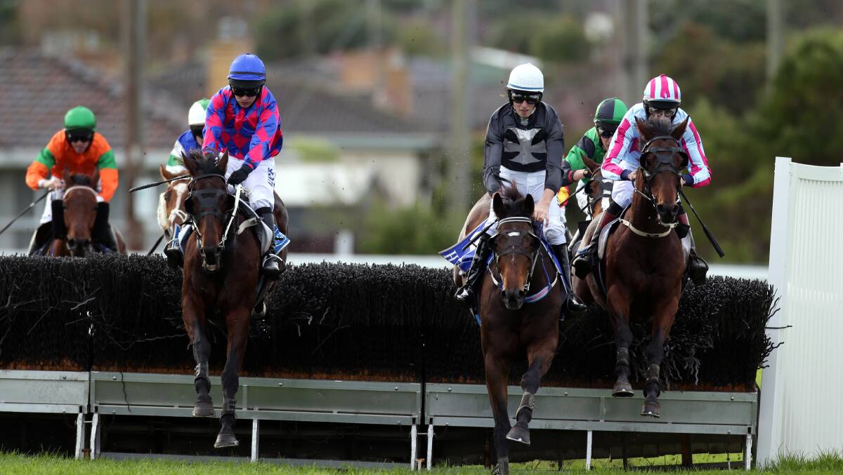 Steeplechase winner Jooli Lad (far right), ridden by Richard Cully, takes the short cuts on the inside as he clears the last fence before passing third placegetter Sea Town (middle), ridden by Braidon Small, and second placegetter Universal Sound, ridden by Tom Ryan, on the left. 