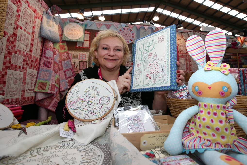 Melbourne visitor Rosalie Quinlan is surrounded by needlework at the Craft Alive show, held at Warrnambool Stadium. The three-day program of displays and workshops attracted big crowds. 140712DW44 Picture: DAMIAN WHITE