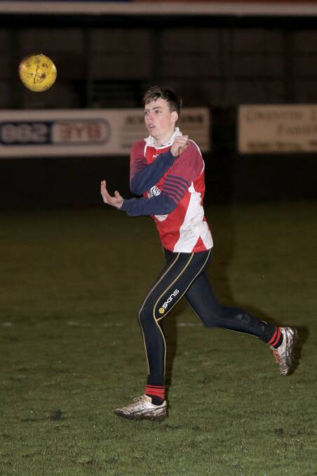 South Warrnambool youngster Jeremey Stacey works on his hand skills at pace last night during training at Friendly Societies’ Park. 140807RG36 Picture: ROB GUNSTONE