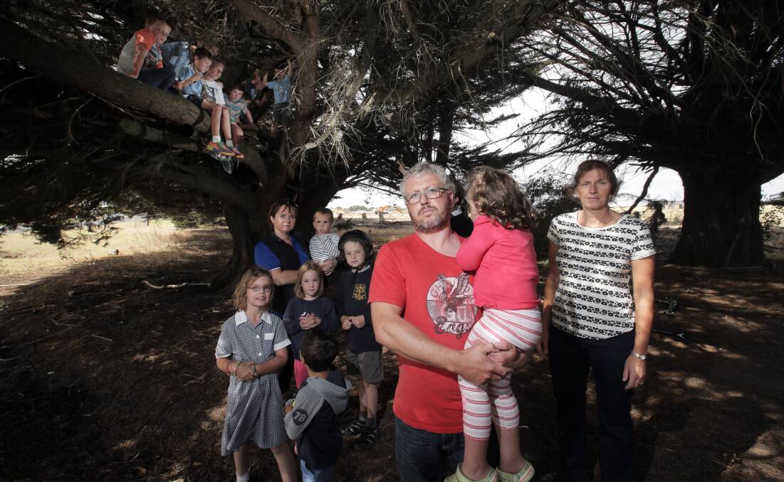 North Warrnambool parents Sonia Kelly (back left), Dean Fleming, holding daughter Sage, 4, and Daphne Ginley want cypress trees kept along Mortlake Road.