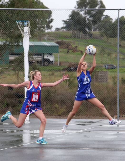 Panmure's Kirsty Williams defends Russells Creek wing attack Jess Price on a damp playing surface. 