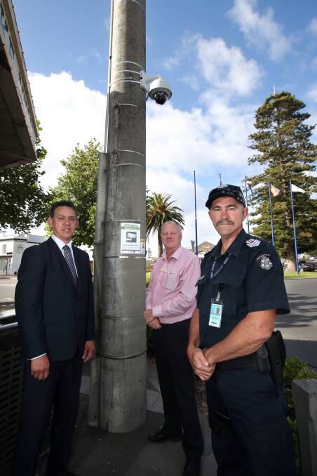 Mayor Michael Neoh (left), city local laws co-ordinator Peter McArdle and Senior Sergeant Russell Tharle, from Warrnambool police, at one of the CCTV cameras. 141224DW07 Picture: DAMIAN WHITE