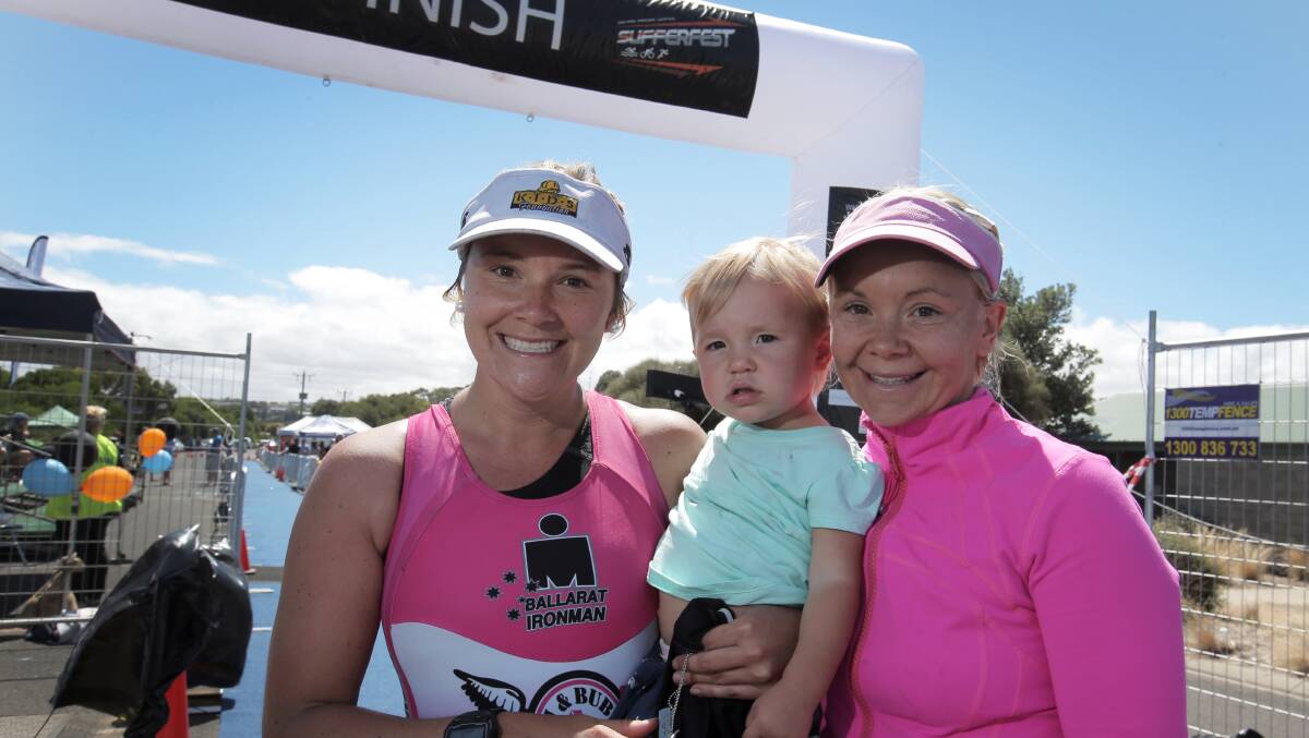Sufferfest women’s winner Emma O’Neill (right) celebrates with her fellow competitor and sister Kate O’Neill and Emma’s 18-month-old daughter Nellie.
