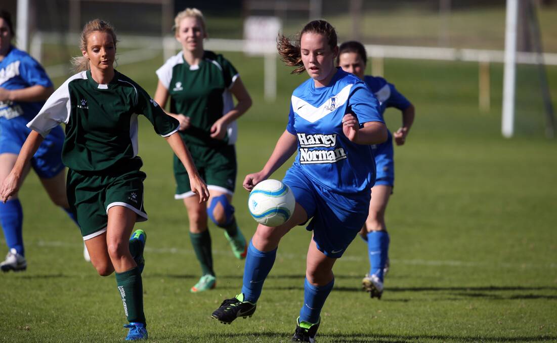 Warrnambool player Izzy Wilkinson controls the ball, shadowed by from Forest's Rachel Cameron. 