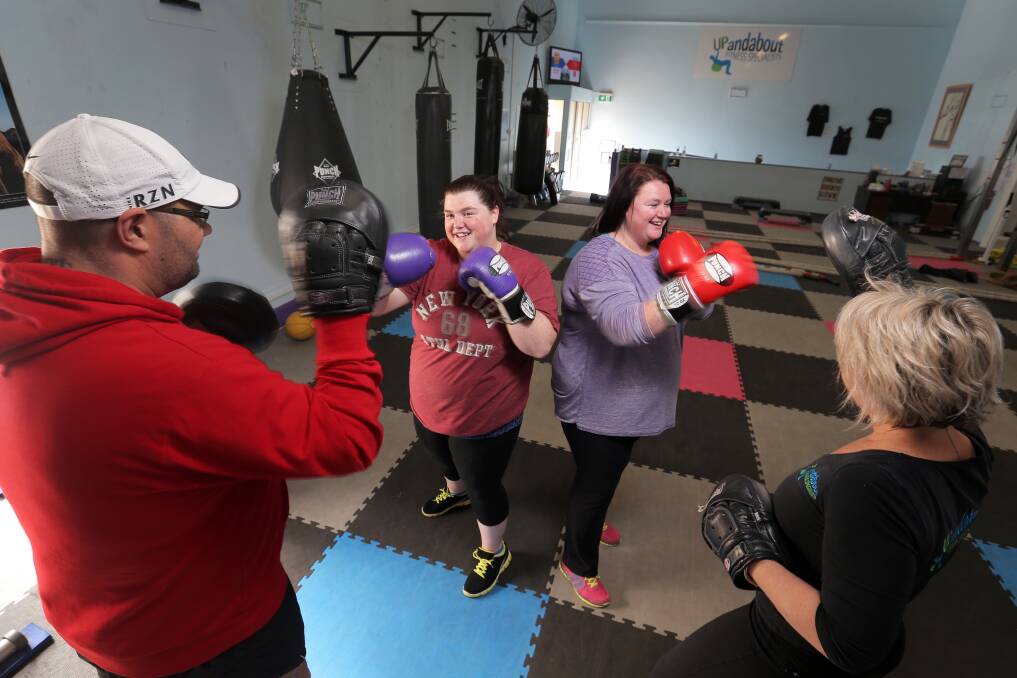 Anti-bullying campaign sisters Leah (centre left) and Amanda Bolden work out under the supervision of Up and About Gym owners ‘Bear’ and Nikki Dixon, who are providing free training to build fitness and confidence. 140902RG09 Picture: ROB GUNSTONE