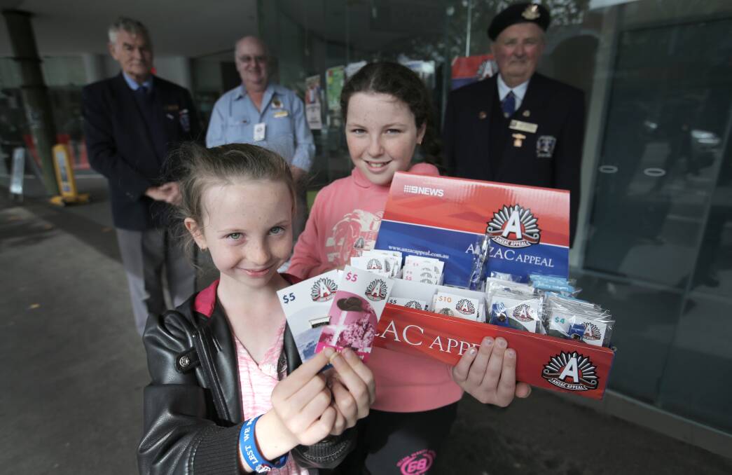 Alyssa Miles-O’Bray, 8, (left) and Tiarn Haberfield, 12, help Warrnambool RSL members Clive Hewett, John Miles (president) and Vern Delaney promote the Anzac Day fund-raising badges in Koroit Street. 
