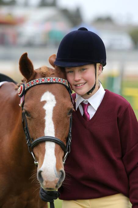 Makayla Lowther, 11, and Forever Zoe share a break between interschool dressage competition yesterday at the Warrnambool show. They will be in action every day. 141023VH11 Picture: VICKY HUGHSON